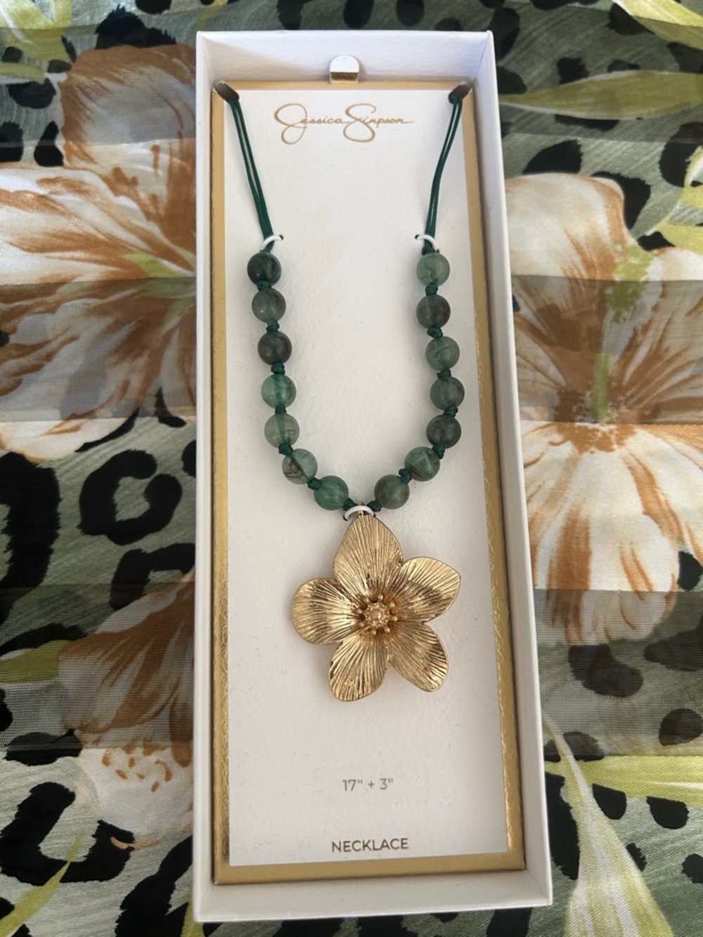 Jessica Simpson flower, pendant, and green acrylic bead cord necklace.